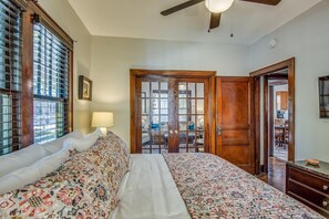 Beautiful french doors open into the living room and have privacy curtains. 