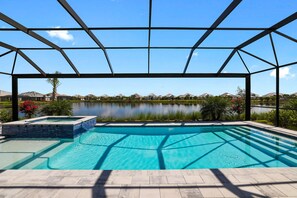 Panoramic view from the lanai.  Gorgeous pool, spa, plantings and water view.