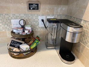 An initial supply of coffee pods and light breakfast items are provided.