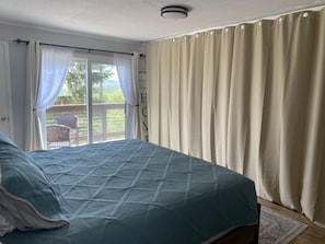 Bedroom with room dividing curtain for dressing & sleeping privacy.