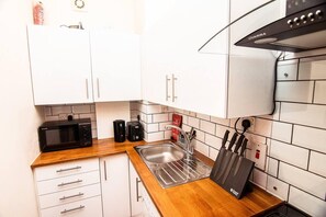 Full kitchen with cooking hub, extractor, microwave, washing machine etc.