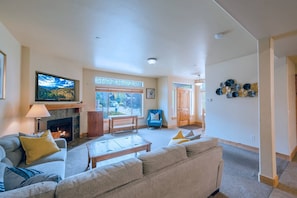 The warm and welcoming living room has 2 new comfortable sofas, gas fireplace and HDTV