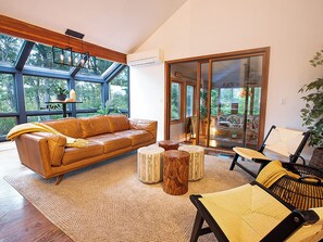 Cape Cod Villa's living room. Enjoy the warmth of the fireplace and pond views