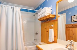 guest bathroom with jacuzzi bathtub and plush towels