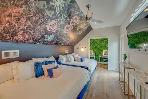 Inviting third-floor loft features 2 queen beds, 2 twins, a glam station, and a rooftop access for added allure.
