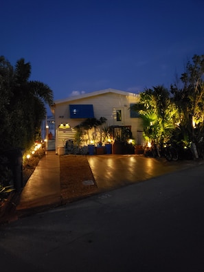 Driveway view of the cottage with lots of solar lighting