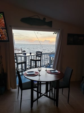 Outside bar seating on the deck and a small dining table inside