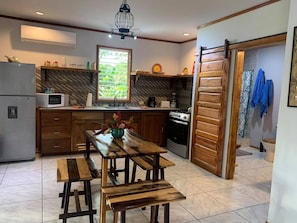 Custom dining table, chairs and full kitchen. Big A/C Unit!!