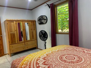 Master Bedroom with queen bed, night tables, lights, fan and armoire