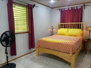 Master Bedroom with queen bed, night tables, lights, fan and armoire