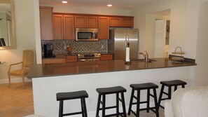 Open kitchen area with additional seating  at bar. Fully furnished.