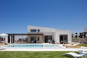 Patio doors open to the veranda and pool area providing a seamless transition