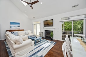 This beautiful open living area has ample seating, a smart TV AND a seasonal fireplace