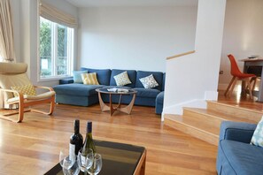 Lounge area in the open plan living space with double doors onto the lakeside sun deck