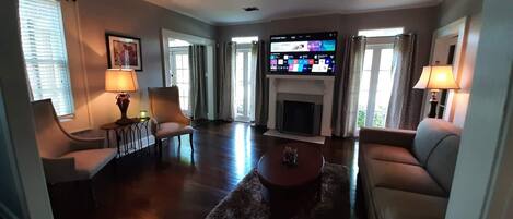 Open concept living room and dining room with 65" Smart TV