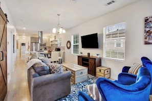 Inviting living area with an open floor plan into the dining and kitchen. Perfect for entertaining and making memories!