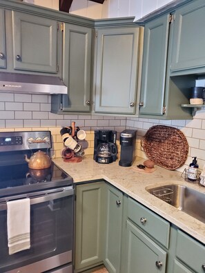 Coffee station with an assortment of cute mugs!