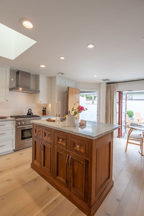 We boost a Carrara Marble center kitchen island. 