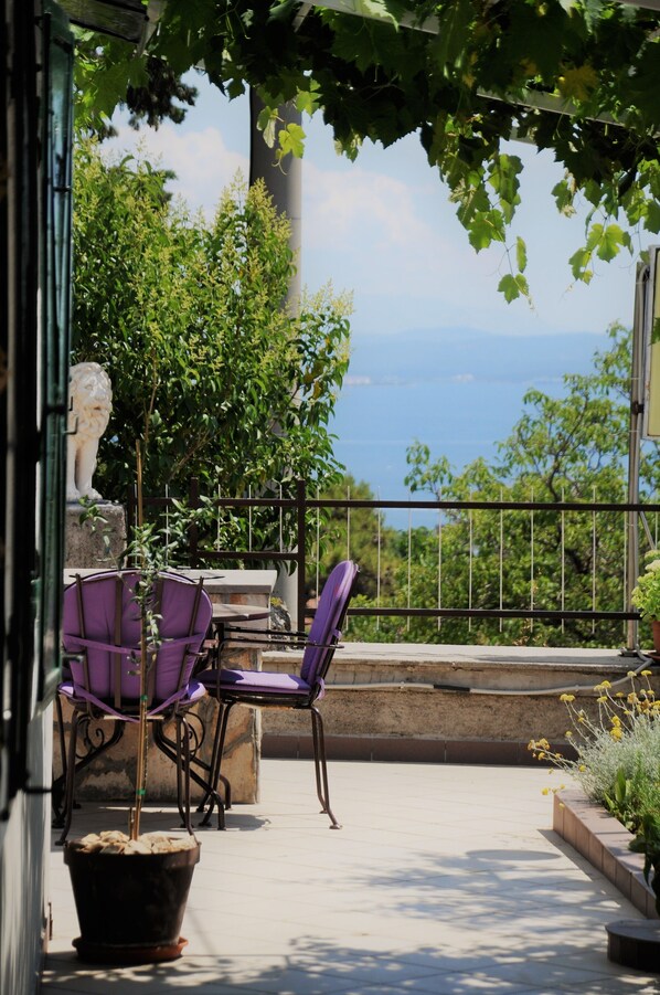 Terrace with the sea view surrounded with Mediterranean greenery.