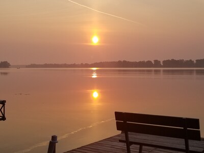 View of the sunrise off our pier with a bench on which to relax with AM coffee