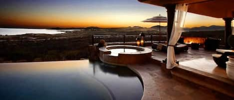 pool and hot tub with sunset view