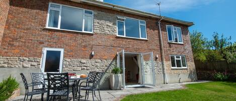 Avocet House, West Lulworth: The rear garden with furniture