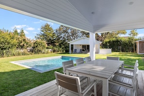 Large inground heated swimming pool in spacious fenced in backyard w/ poolhouse