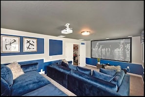 Watch your favorite movie in the Private Theater Room with oversized couches!