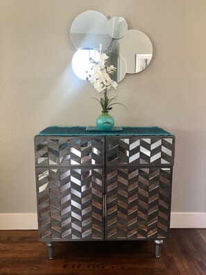 mirrored credenza is stocked with games, crafts and puzzles. 