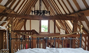 Vaulted ceiling with original oak and elm beams and wrought iron candelabras