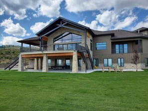 Back yard with large deck, covered patio and hot tub