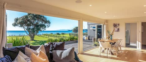 Open plan living and dining onto large Deck with seaview