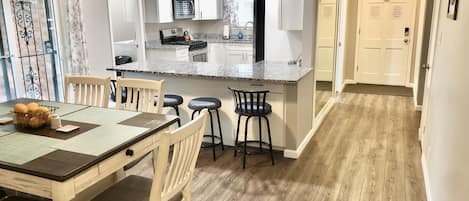 Dining room and kitchen. Dining table seats 6 and island has 4 bar stools 