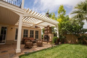 Back patio with outdoor fireplace