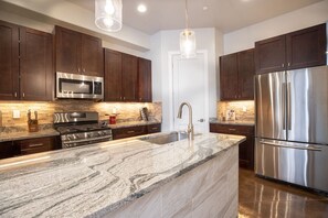 Fully stocked kitchen with marble countertops