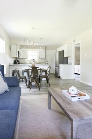Spacious, open-concept design seamlessly connecting the living room and kitchen for a bright and airy feel.