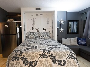 The comfortable queen bed, with 12" memory foam mattress, sleeps two people comfortably.