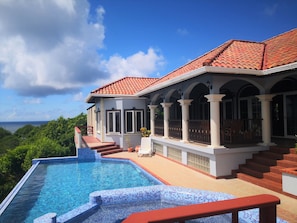 Ocean facing side of house. Pool and Patio area.