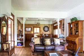 The living room maintains an old-world feel while still having modern touches: relax amongst the antique furniture and enjoy the Smart TV & Bluetooth speaker.