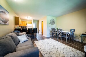 The open-concept living space, complete with a dining area, facilitates effortless conversation with family and friends.