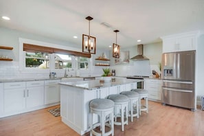 Stunning kitchen with large island with bar seating. Fully stocked.