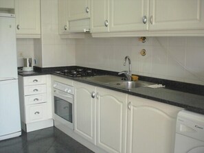 Kitchen,  table, chairs door to balcony sea view