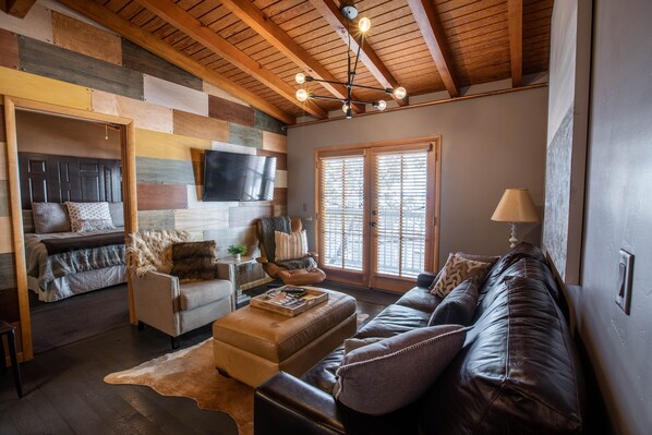 Cozy livingroom with plush leather sofa and cable T.V.