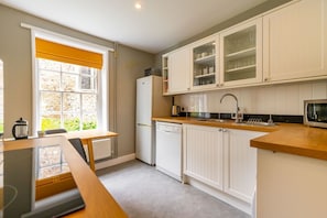 Positioned opposite the living room you'll find the fully equipped kitchen.