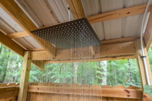 Stand under the rainfall shower outside. 
