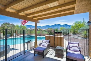 Backyard patio view of mountains and grill. 