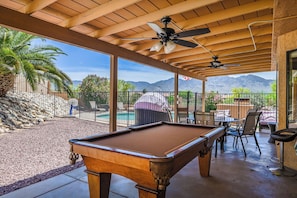 Pool table on backyard patio. 
