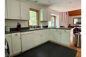 Kitchen view from front door and dishwasher