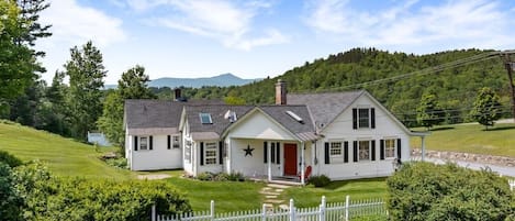 Property exterior with mountain views in the distance.