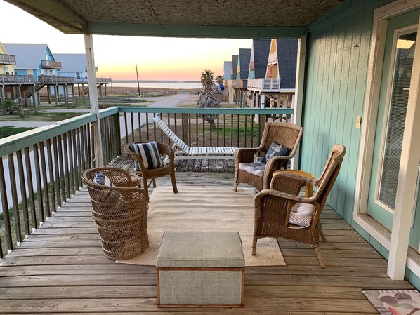 Step out of the primary bedroom to your own seating area with a lakeside view.